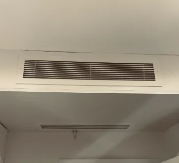 Linear supply grille set into a ceiling bulkhead