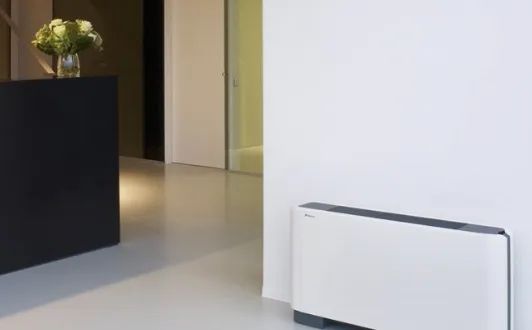 Slim floor-mounted unit against a white wall in a modern interior