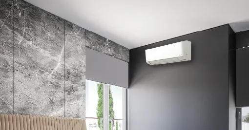 Wall-mounted air conditioning unit high on a dark feature wall