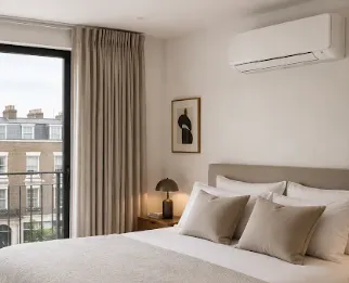 Wall-mounted air conditioning unit above a bed
